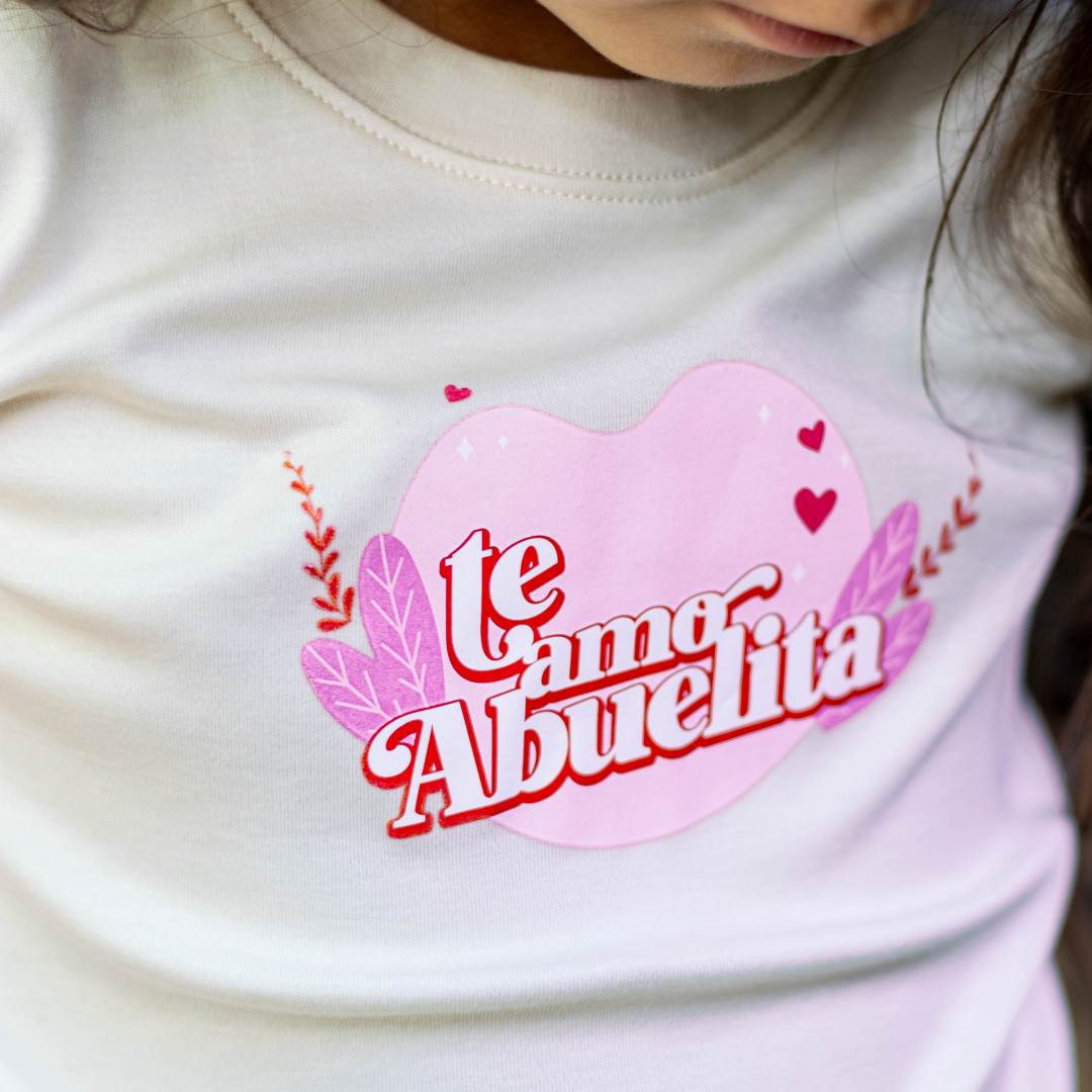 TE AMO ABUELITA ORGANIC GRAPHIC TEE. Crafted from the finest GOTS-certified organic natural colored Pima cotton from Peru, this tee is as gentle on your child's skin as it is on the environment. The soft, breathable fabric