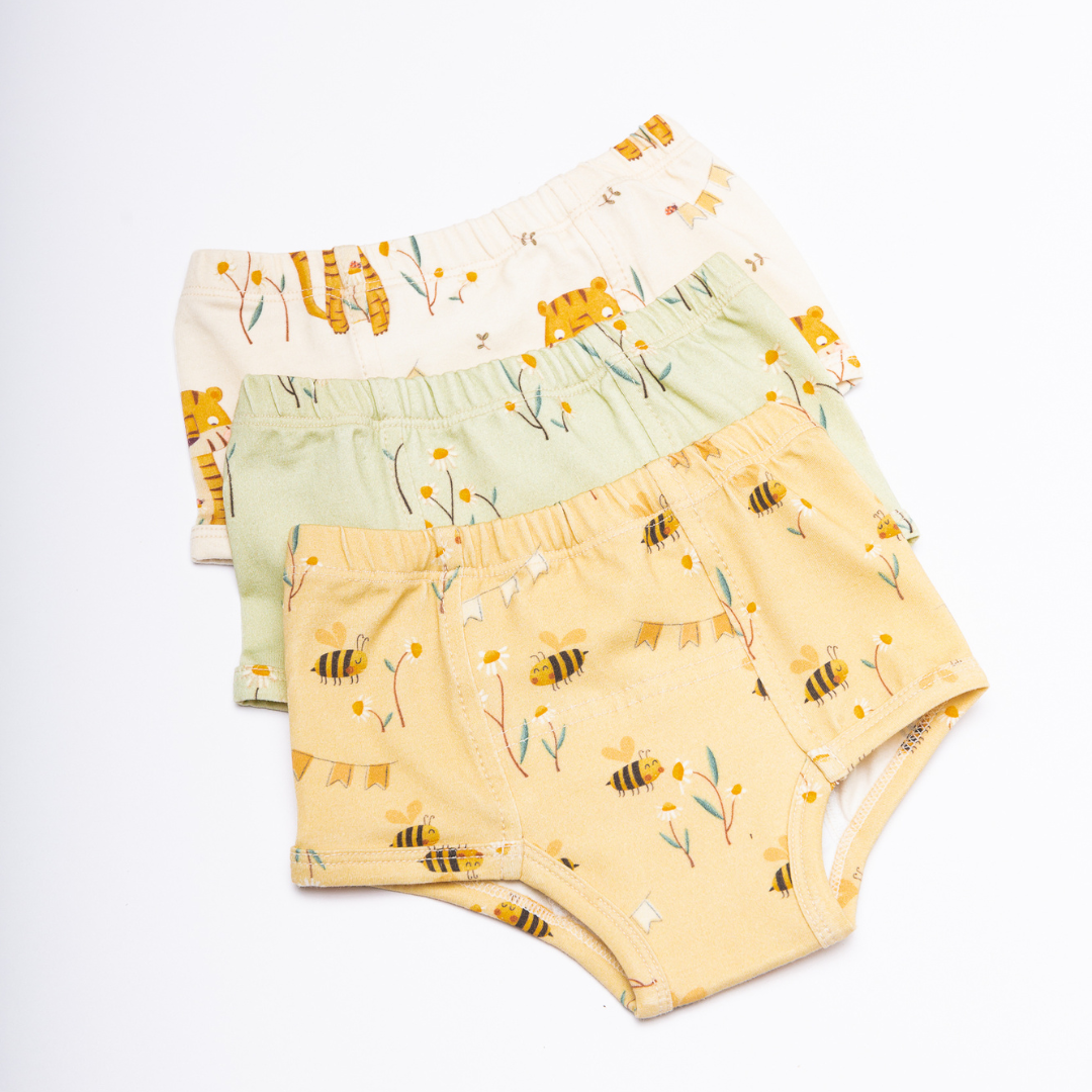 Three organic potty training with prints of bees in yellow, daisies over green and tigers over cream background